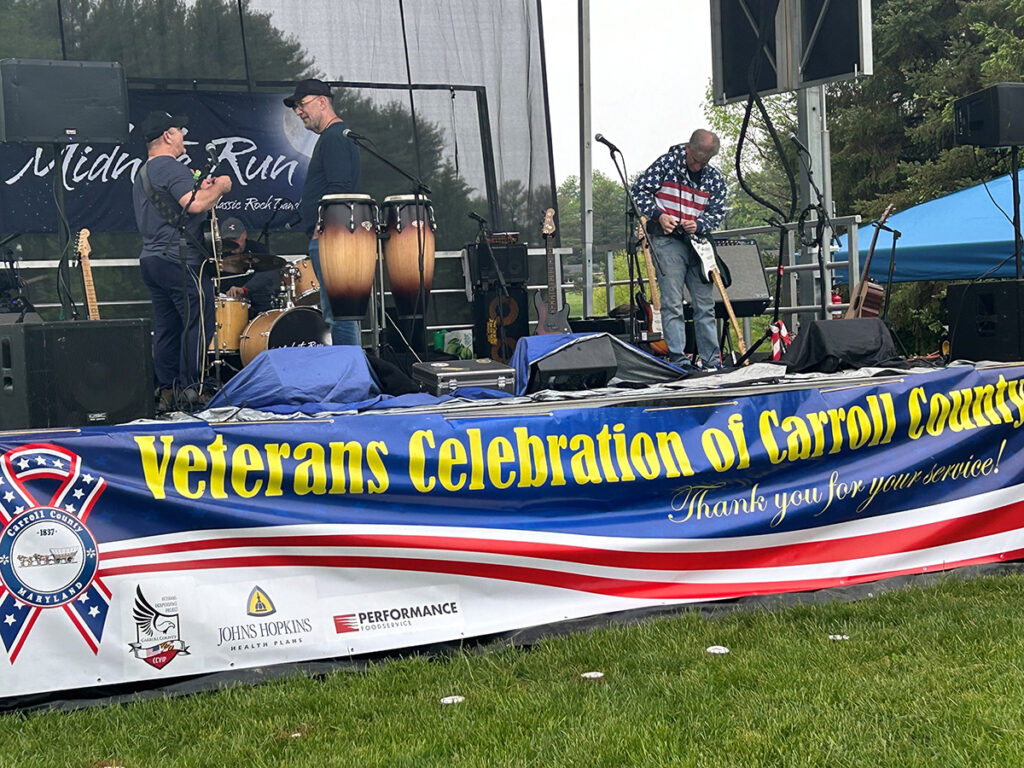 Band setting up on stage at the Veterans Celebration of Carroll County event.